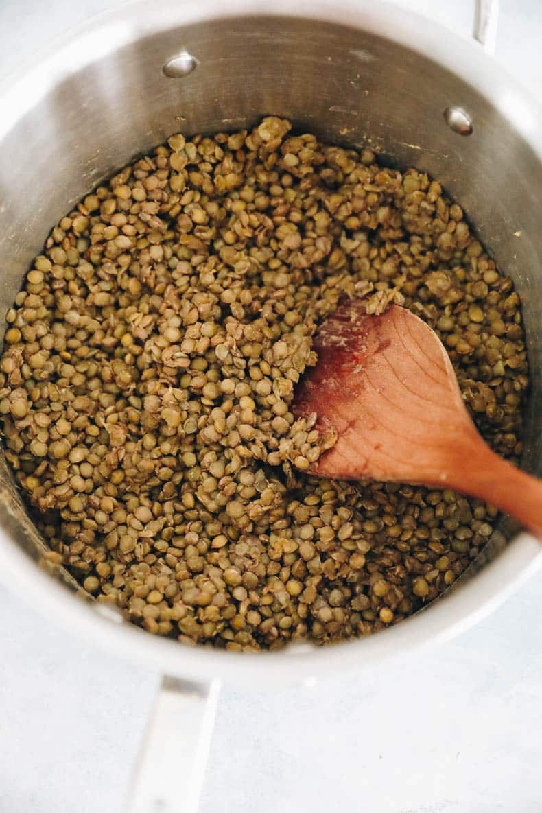 Cooked french lentils in pot.