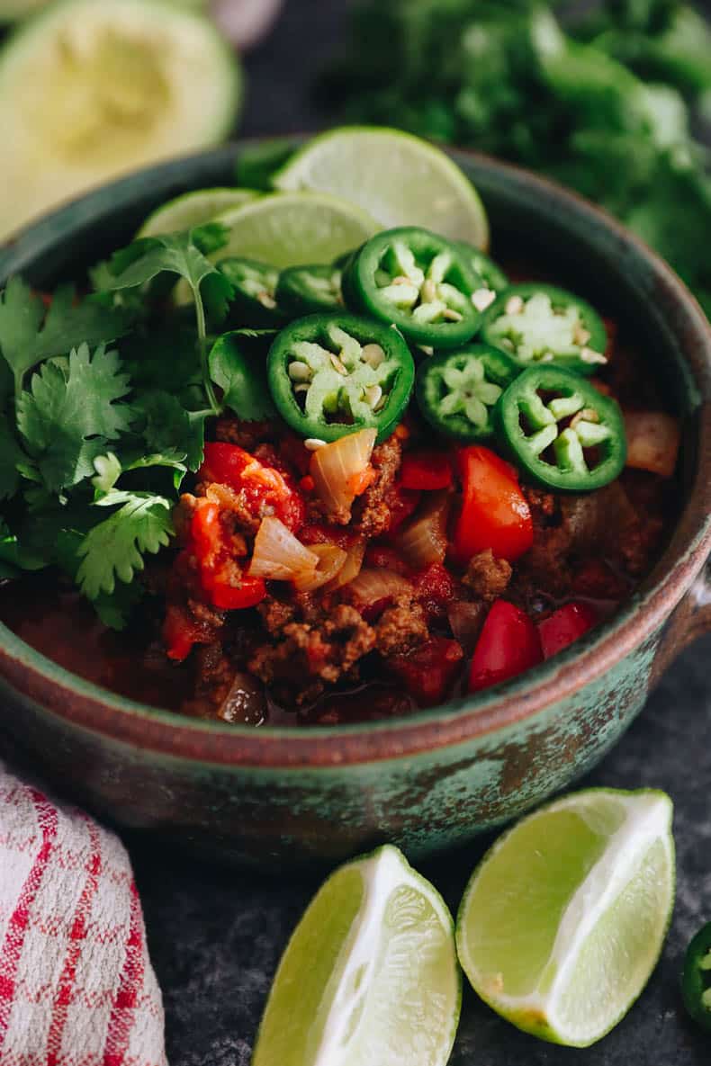 No Bean Chili in a bowl topped with jalapeno, lime and cilantro.