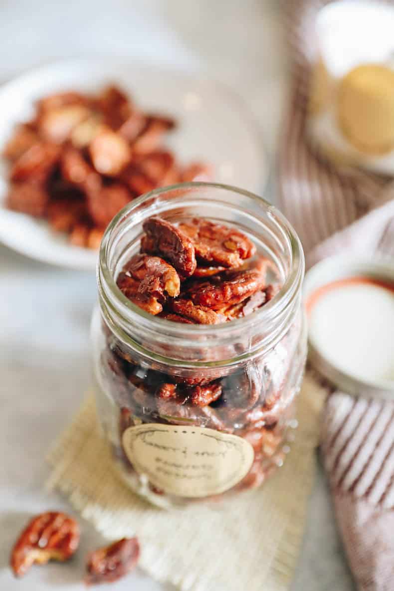 sweet and spicy roasted pecans in a mason jar.