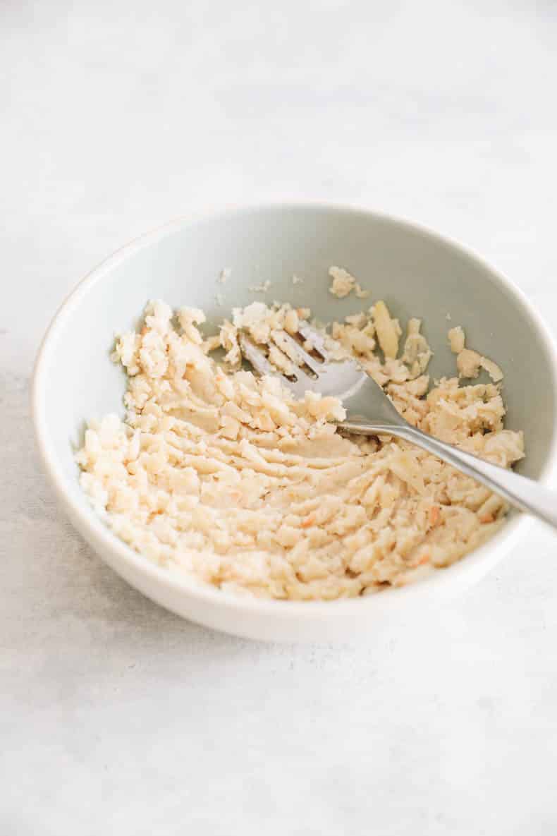mashed white beans in a blue bowl.